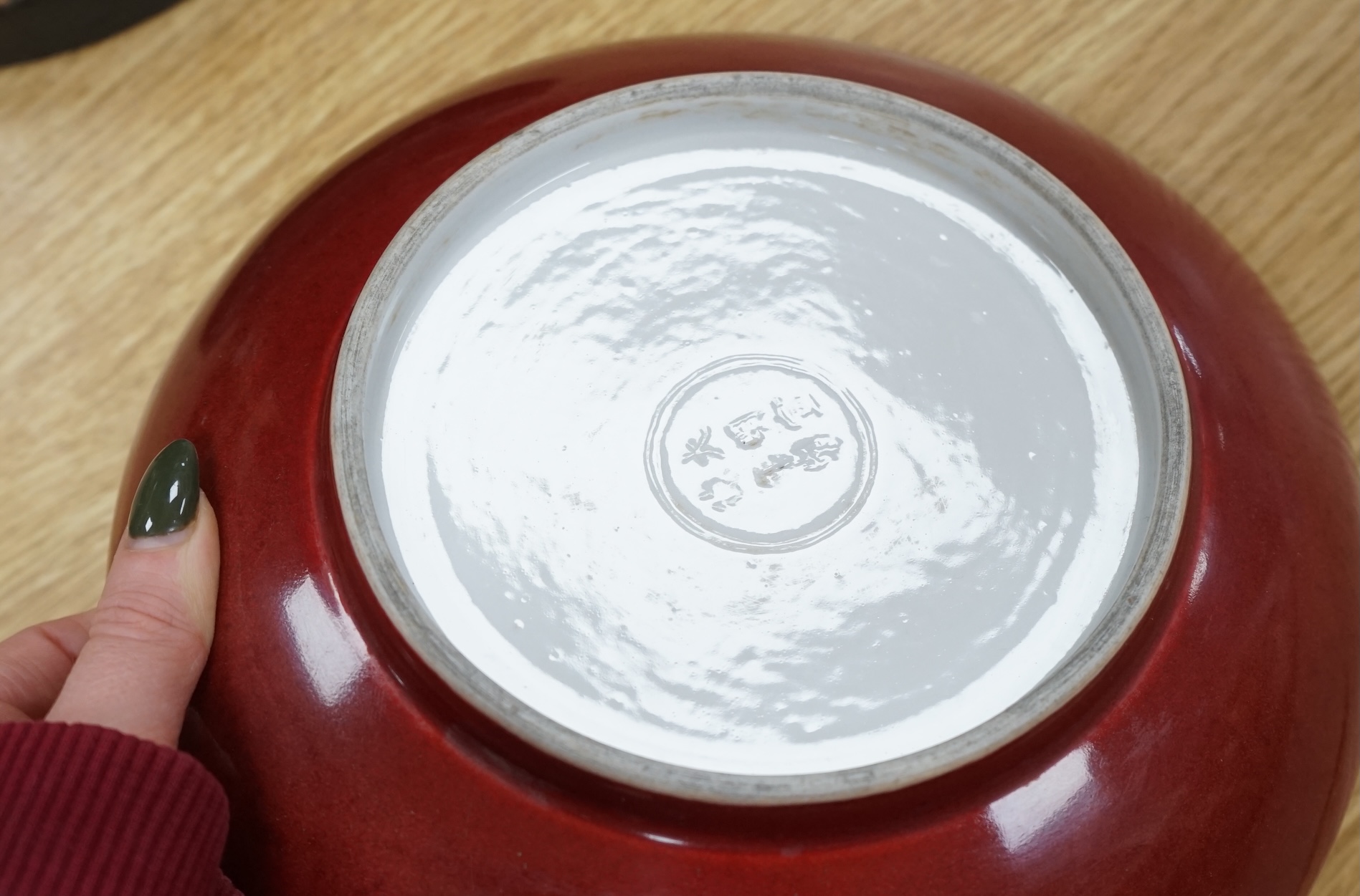 A Chinese copper red glazed dish, a blue and white bowl and a similar dish, bowl 22.5cm diameter. Condition - good